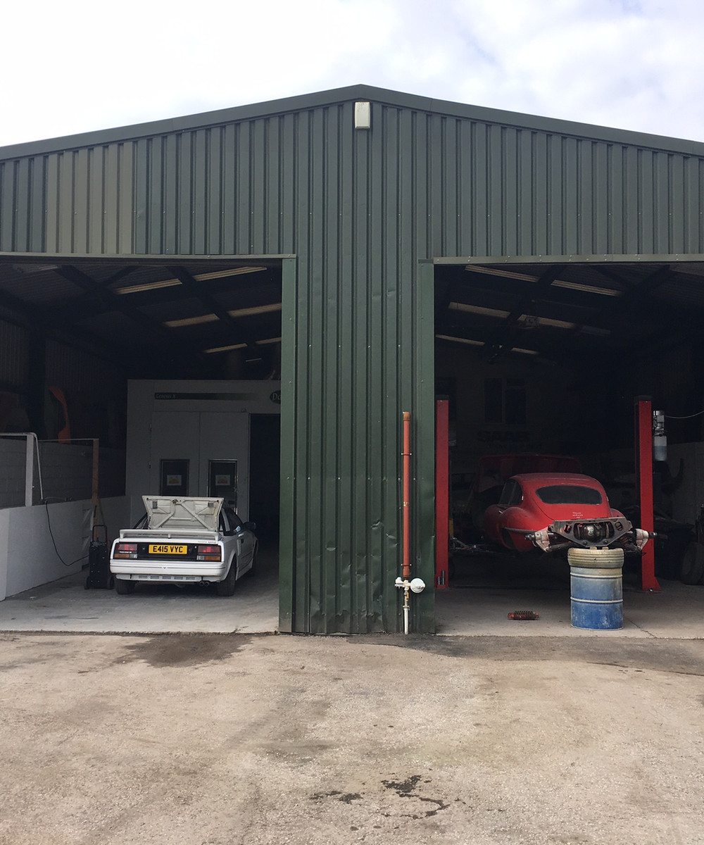 Two classic cars inside Sixteen80's Knaresborough workshop